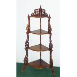 Victorian walnut corner whatnot of four shaped graduated tiers with inlaid stringing,