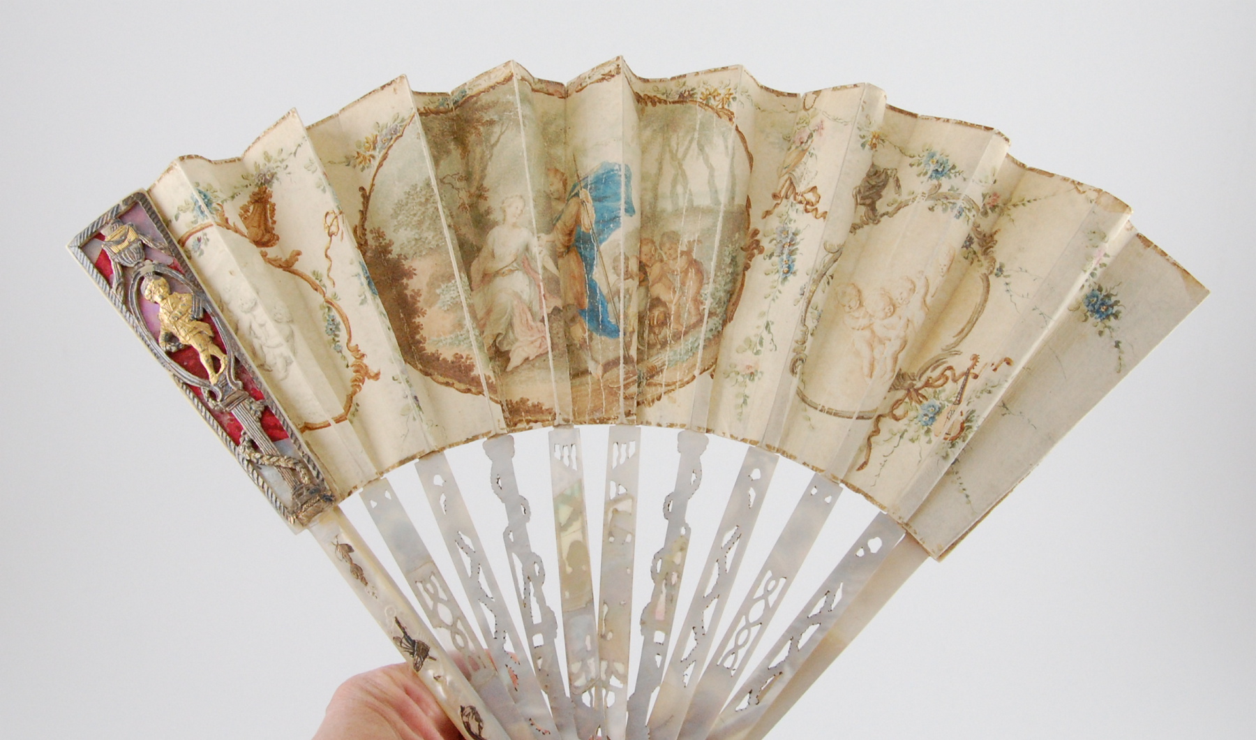 French late 18th century fan with painted scene & putti & silver pierced & gilt overlaid mother of