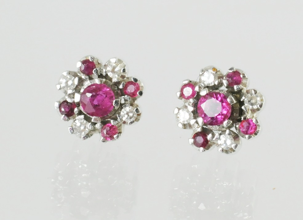 Pair of ruby & diamond earrings, each with five rubies & four mixed cut diamonds, in white gold.