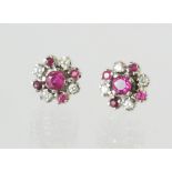 Pair of ruby & diamond earrings, each with five rubies & four mixed cut diamonds, in white gold.