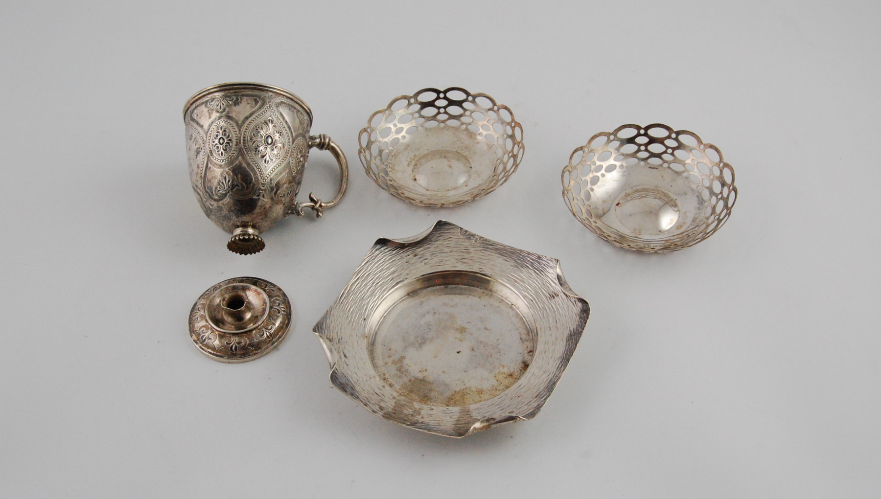 Silver embossed cup, the foot detached, 1865; two pierced circular dishes & another, hammered.