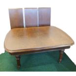 Victorian oak wind out extending dining table, the moulded edge top with curved ends & three leaves,