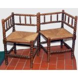 Pair 19th century bobbin turned corner chairs, rush seats, possibly stained beech. (2).