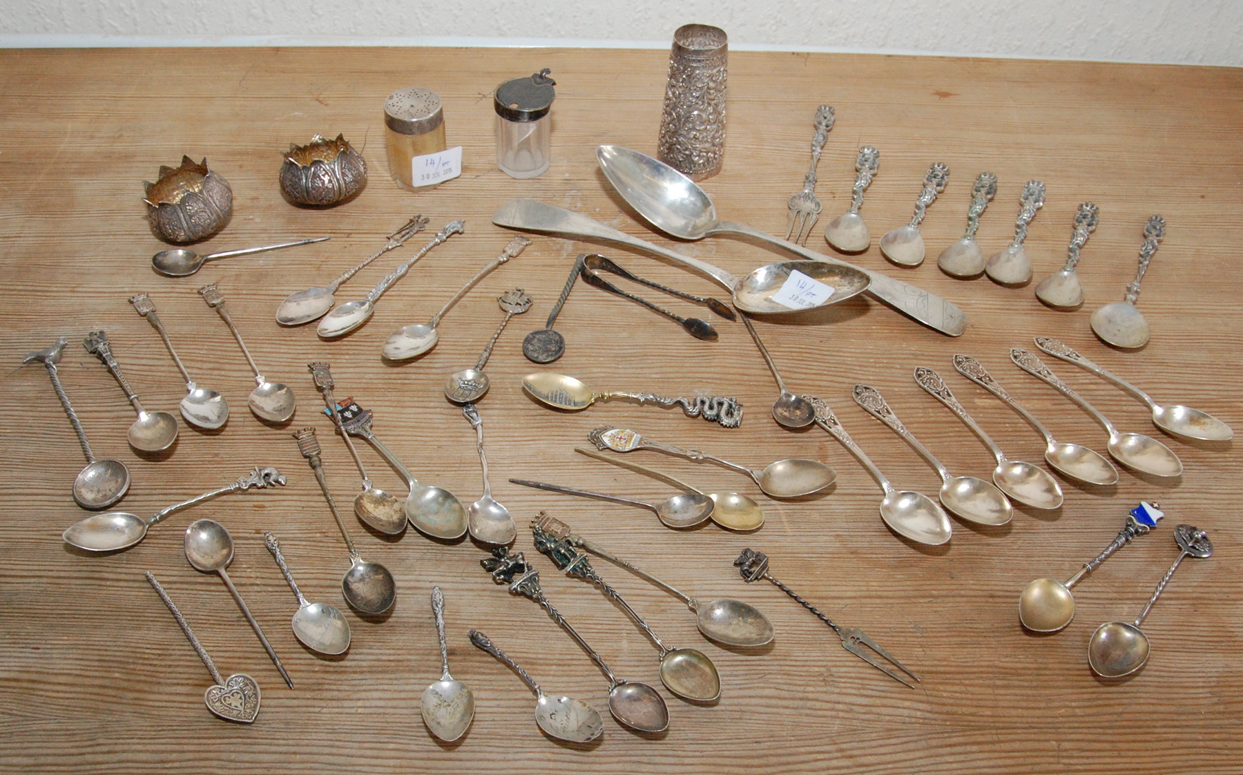 Indian silver embossed double measure; a pair of similar bowls & various Continental & other spoons,