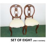 Set of eight Victorian walnut dining chairs, each with carved oval back with leaves,