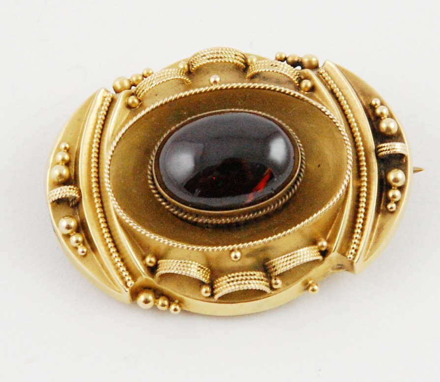 Victorian gold oval brooch with cabochon garnet & looped cannetile & beaded decoration, locket back.