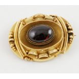 Victorian gold oval brooch with cabochon garnet & looped cannetile & beaded decoration, locket back.