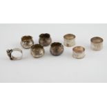 Set of four silver hammered salts with waved edges, 1884; a napkin ring with bear & three others,