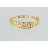 Fine gold hinged bangle, probably Indian, with openwork sprays of diamond brilliants.