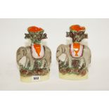 Pair of Staffordshire spill holders (fcing same way), each in the form of an elephant on oval base,