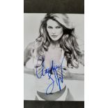 GLAMOUR, signed 8 X 10 by Claudia Schiffer, half-length in revealing white top, EX