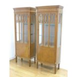 Pair of English Sheraton style vitrine cabinets In satinwood with inlay, and lattice glass door.