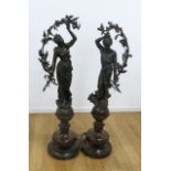 Pair of patinated metal statues of male & female Mounted as lamps on wood bases. French 20th c.