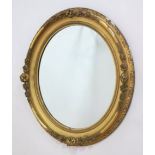 19th c. gilt wood oval mirror Approx. 39" H x 34" W. Minor chips to gesso Minor chips to gesso