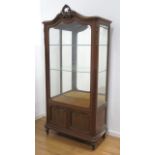 French Louis XVI style wreath top vitrine cabinet In mohogany. With glass doors and bronze trim.