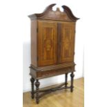 Continental Baroque Oak Cabinet on Stand Mid 18th Century. With pediment enclosing tablet  dated