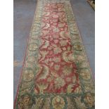 Handmade Red Carpet with Green Border Approx. 12' H x 4' W.