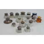 11 Inkwells with Silver Lids Including 4 glass inkwells & 1 porcelain inkwell.  Assorted sizes. 16