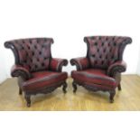 Pair Red Tufted Leather Arm Chairs Approx. 43" H x 38" across back.