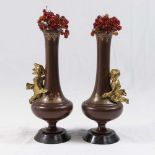 Pair of Patinated Bronze Vases with Cupid Relief With glass flower inserts. Approx. 6 1/2" H.