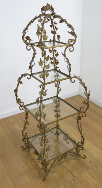 4 Tier Gilt Metal Floral Glass Stand Approx. 52" H x 19" W x 19" D. Crack in glass on  second