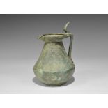 Roman Bronze Wine Jug 2nd-3rd century AD. A broad hollow-cast jug with discoid base, tapering