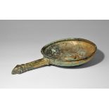 Roman Bronze Patera with Ram's Head Handle 1st-2nd century AD. A sheet-bronze pan with rolled rim