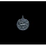 Viking Bronze Pendant with Regardant Beast 11th century AD. A cast discoid pendant with pierced lobe