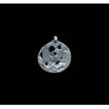 Viking Silver Pendant with Regardant Beast 10th-12th century AD. A flat-section discoid pendant with