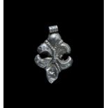 Medieval Silver-Gilt Fleur-de-Lys Pendant 12th-15th century AD. A hollow-formed repoussé fleur-de-