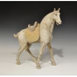 Chinese Ceramic Standing Horse Tang Dynasty, 618-906 AD. A greyware figurine of an advancing horse