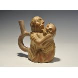 "20th century AD. A glazed ceramic stirrup vessel formed as a long-haired figure with gaping mouth