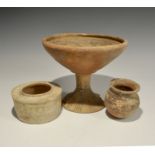 "3300-1300 BC. A group of three terracotta vessels comprising: as pedestal bowl with fish and