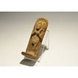 "19th-20th century AD. A ceramic shabti with arms to the chest holding implements, plaque to the