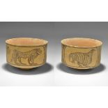 "3300-1700 BC. A terracotta cup with scene of two standing lions and another of a bird. 80 grams,