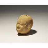 . An undated archaistic hollow-formed terracotta male head with square hole to the upper face. 109