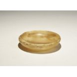 20th century AD. A shallow alabaster dish with rounded rim. 219 grams, 11.5cm (4 1/2"). From a