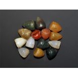 20th century AD. A mixed group of conical stone gaming pieces in carnelian, green jasper and