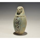 "20th century AD. A blue glazed composition canopic jar with ban of hieroglyphic text to the body,