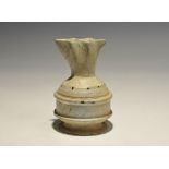 "20th century AD. A white glazed composition jug with cotton-reel foot, ribbed body, domed shoulder,