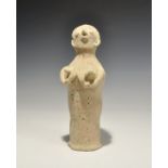 "3300-1700 BC. A tubular ceramic figurine with globular head; applied arms supporting the breasts,