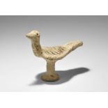 ". An undated archaistic hand-modelled terracotta figure of a bird with discoid base and column in