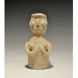 "3300-1300 BC. A bell-shaped ceramic figurine with globular head; applied arms supporting the
