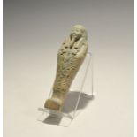 "20th century AD. A green glazed composition shabti with tripartite wig, hieroglyphs to the chest