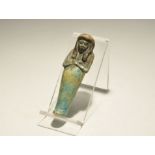 ". An undated archaistic blue-green glazed composition shabti with D-shaped face, large tripartite