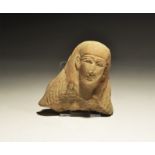 ". An undated archaistic terracotta moulded head fragment with tripartite wig and hatched garment to