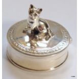 A small silver pill box surmounted with a cat. 18gms