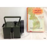 A Military hand held lamp with coloured filters and a book on Gloucester Reg in Korea