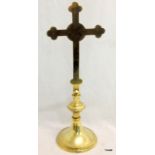 A brass altar crucifix 18 inches high with an etched swastika front and back