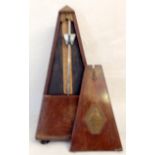 An antique mahogany metronome